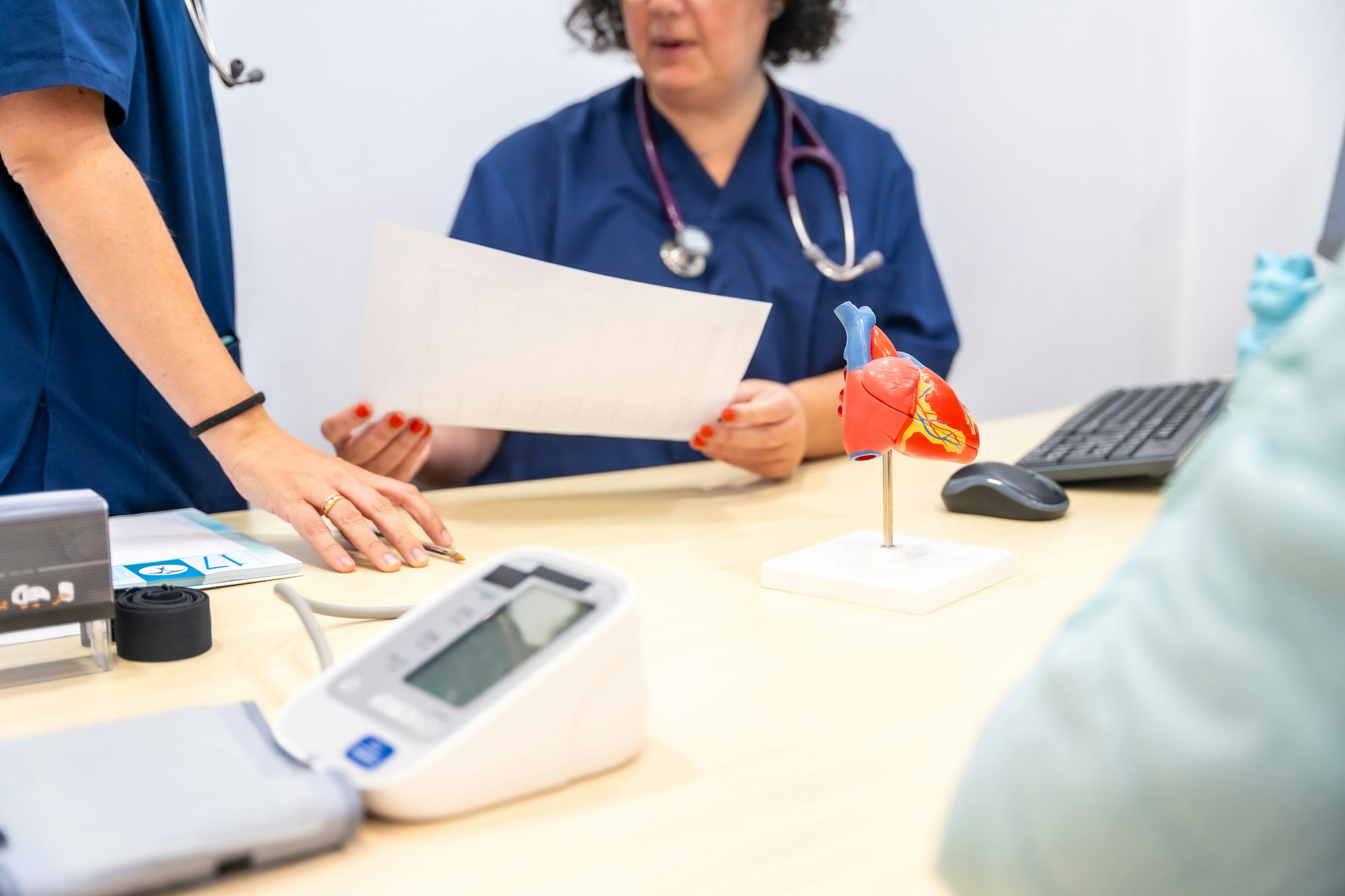 Nurse and doctor sharing paperwork in a cardiology office